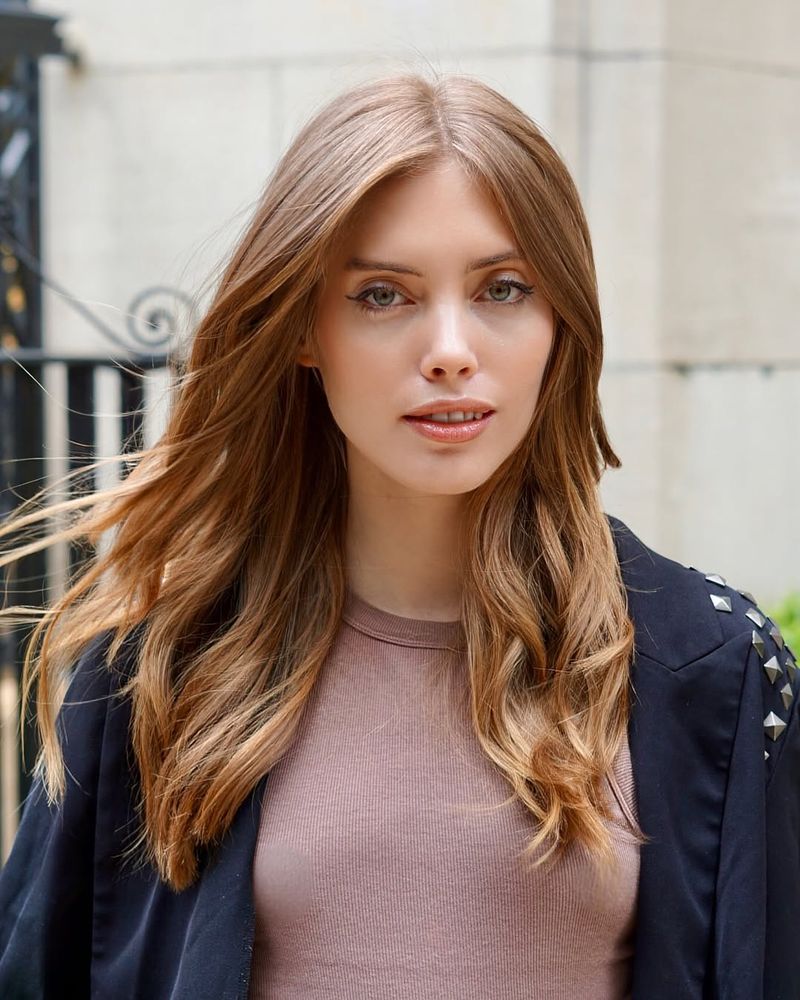 21. Golden Blonde Hidden Layers with Long Curtain Bangs