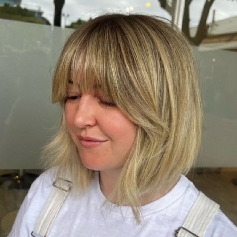 16. Golden Blonde Shaggy Bob with Full Fringe