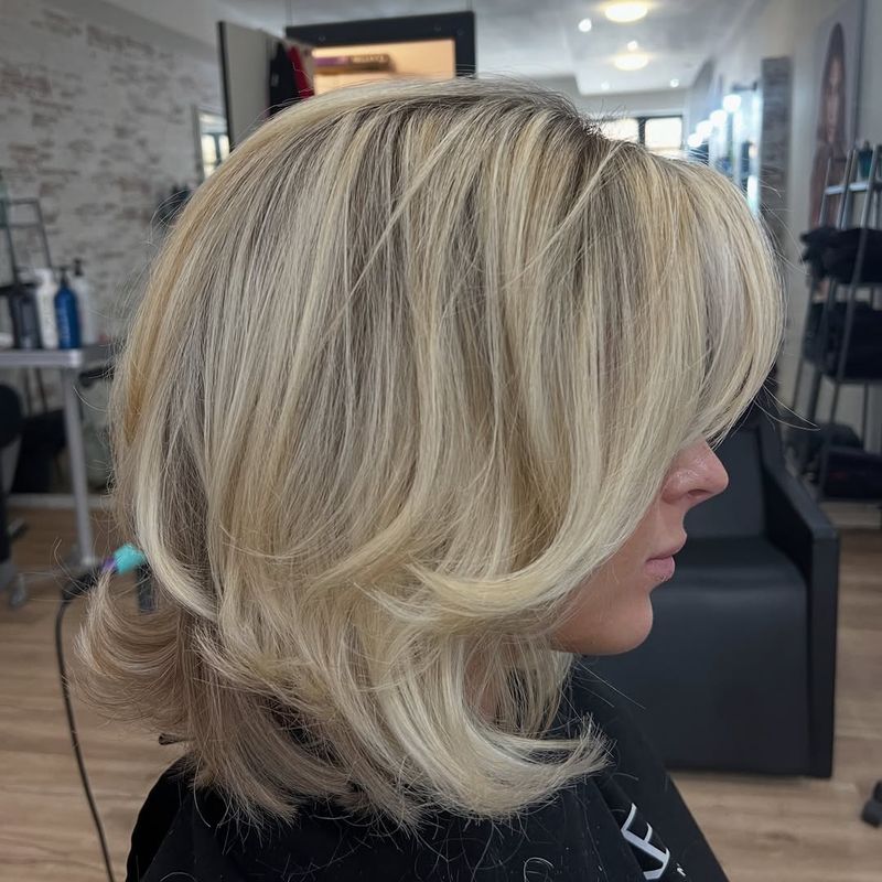 11. Golden Layered Bob with Swooping Fringe