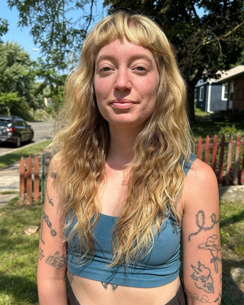 20. Golden Micro Bangs and Wavy Layers