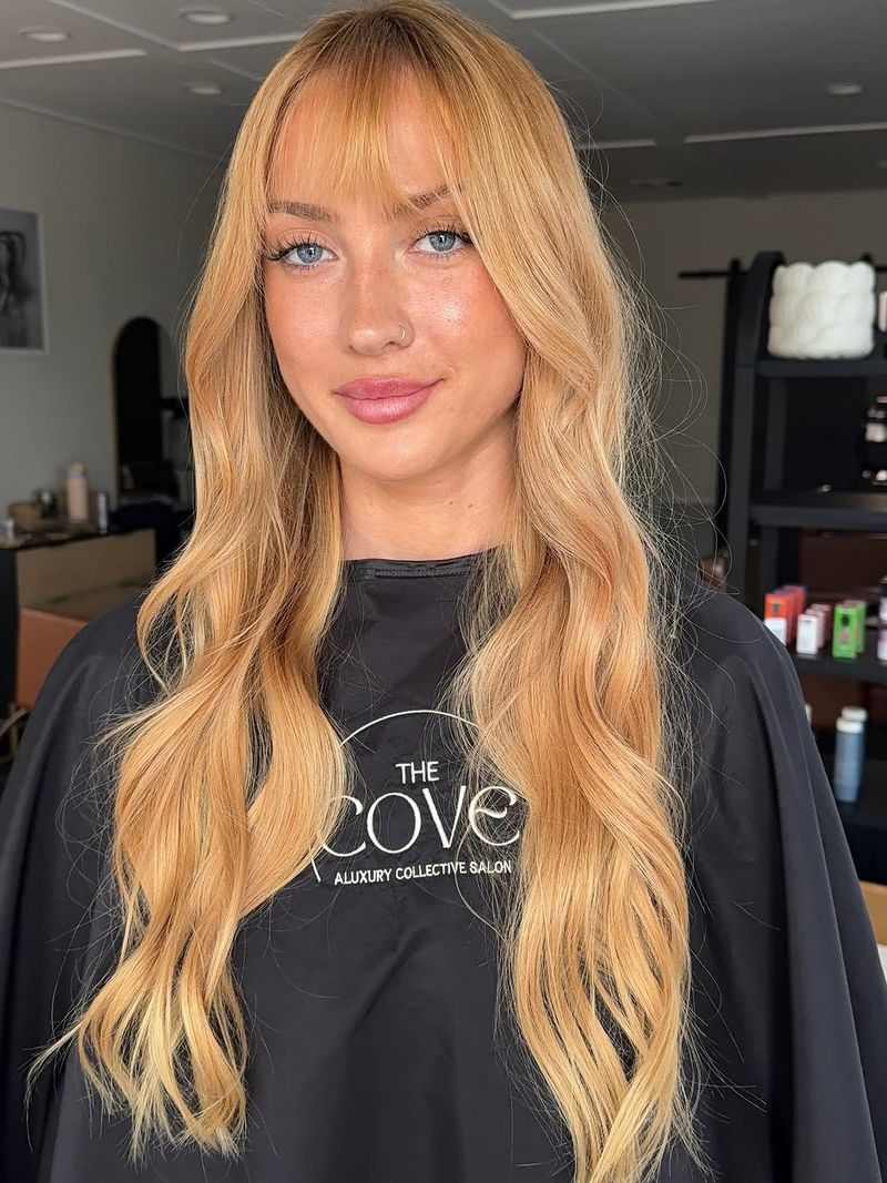 6. Golden Peach Waves with Wispy Bangs