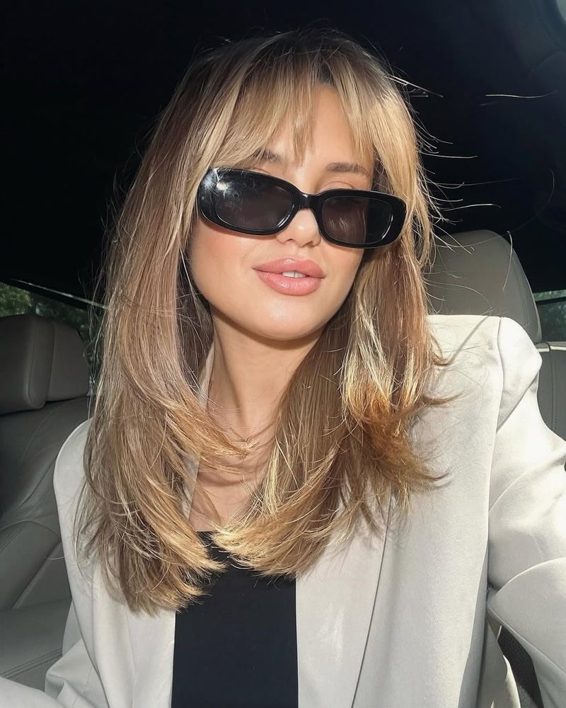 46. Honey Blonde Blowout with Curtain Bangs