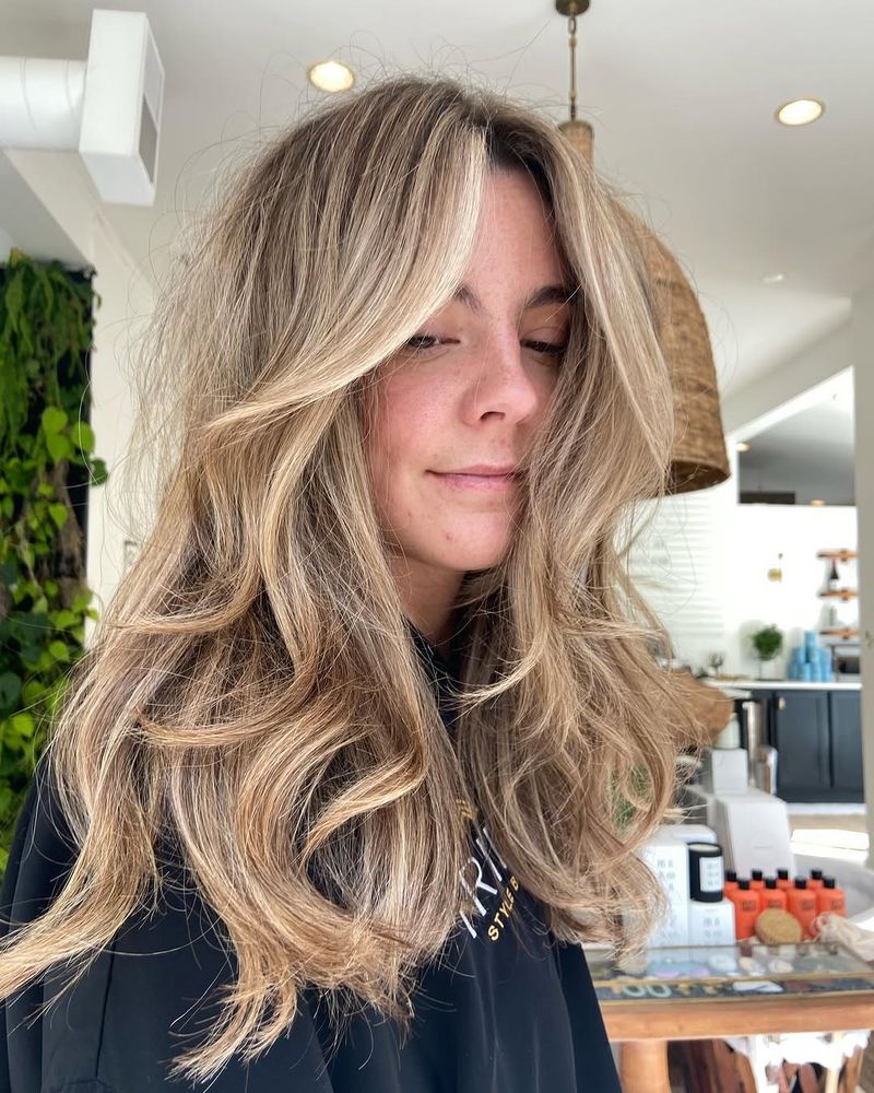 9. Honey Blonde Blowout with Curtain Bangs