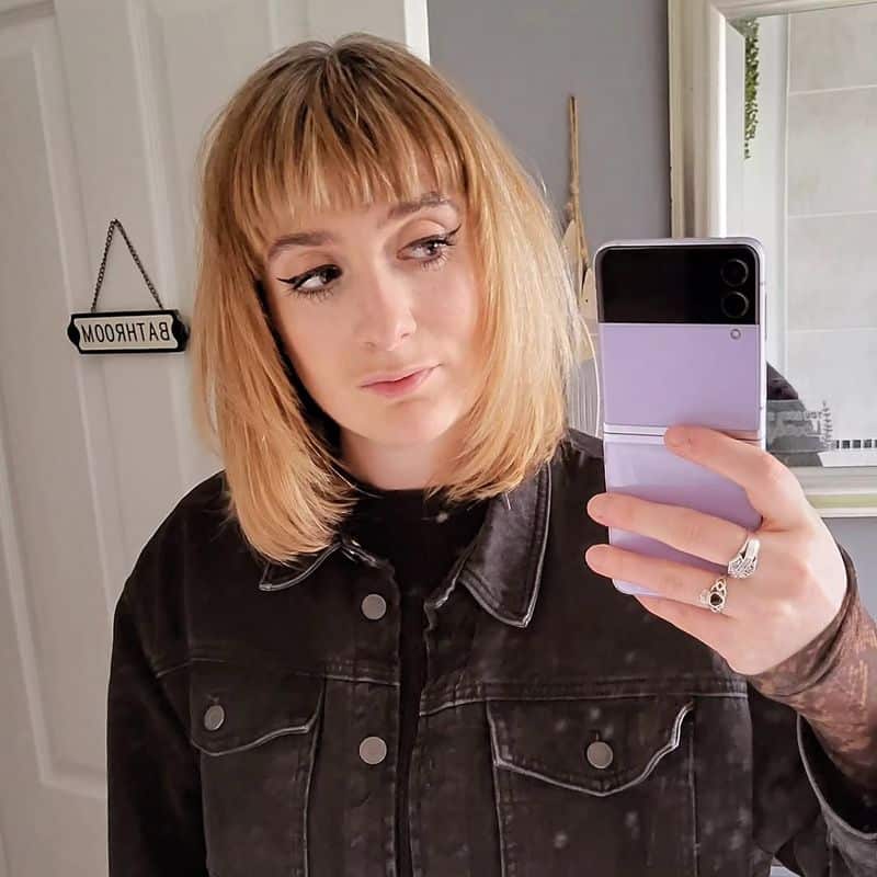 14. Honey Blonde Feathered Lob with Straight Bangs