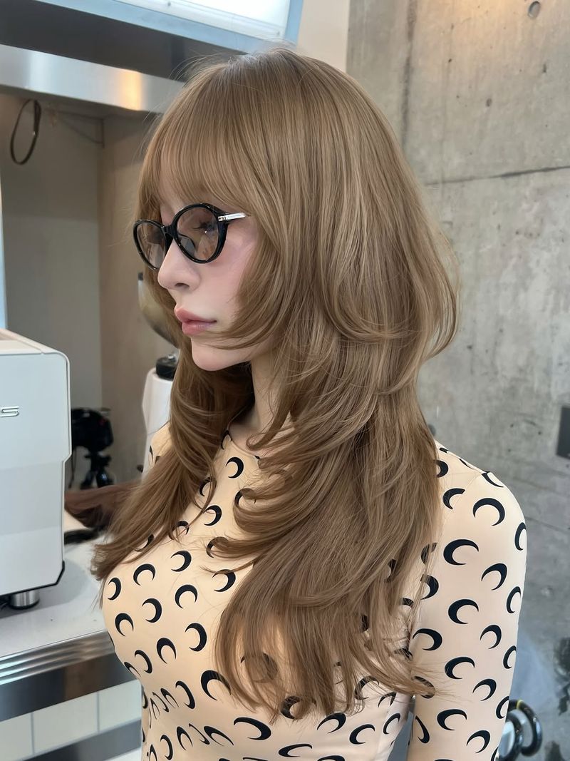 34. Honey Blonde Layered Cut with Rounded Curtain Bangs