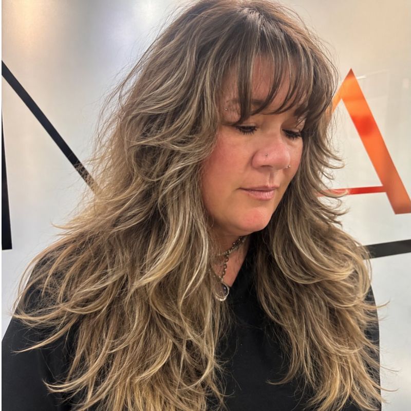 12. Honey Blonde Layered Shag with Full Bangs