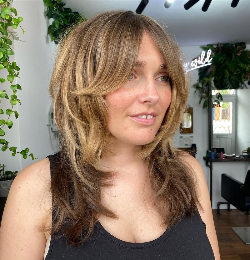 43. Honey Bronde Shag with Curtain Bangs