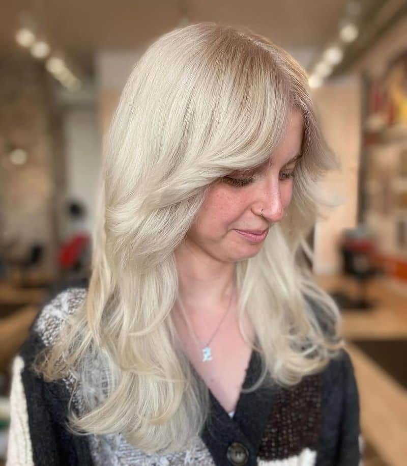 39. Icy Blonde Feathered Layers with Curtain Bangs