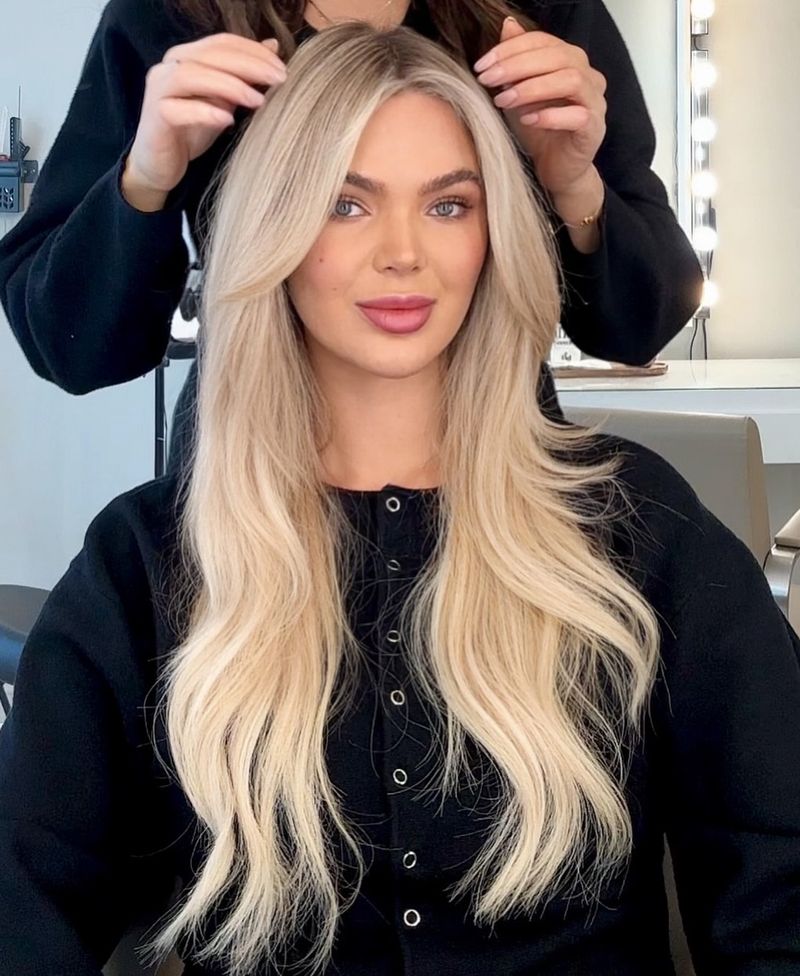 26. Icy Platinum Long Layers with Curtain Bangs