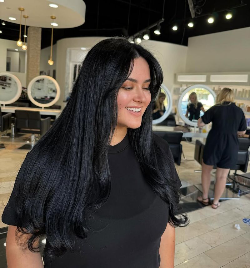 11. Jet Black Blowout with Long Curtain Bangs