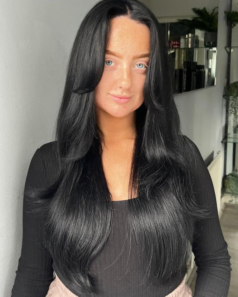 3. Jet Black Blowout with Long Curtain Bangs