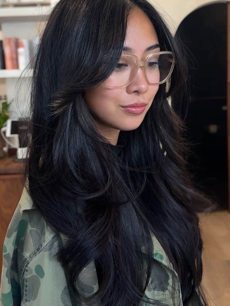 3. Jet Black Blowout with Soft Winged Bangs