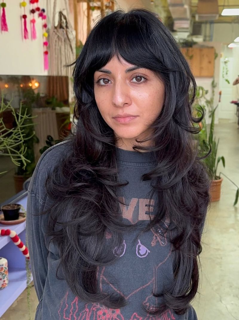 31. Jet Black Feathered Layers with Curtain Bangs