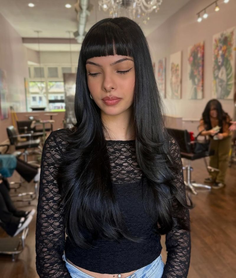 1. Jet-Black Micro Fringe with Cascading Layers
