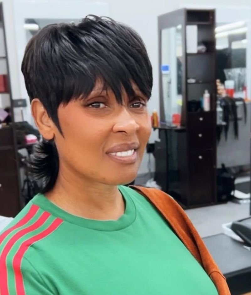 29. Jet-Black Pixie Mullet with Piecey Fringe