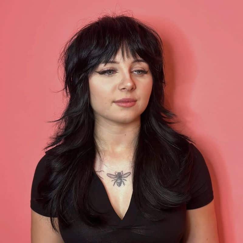 4. Jet Black Shag with Heavy Brow-Skimming Bangs