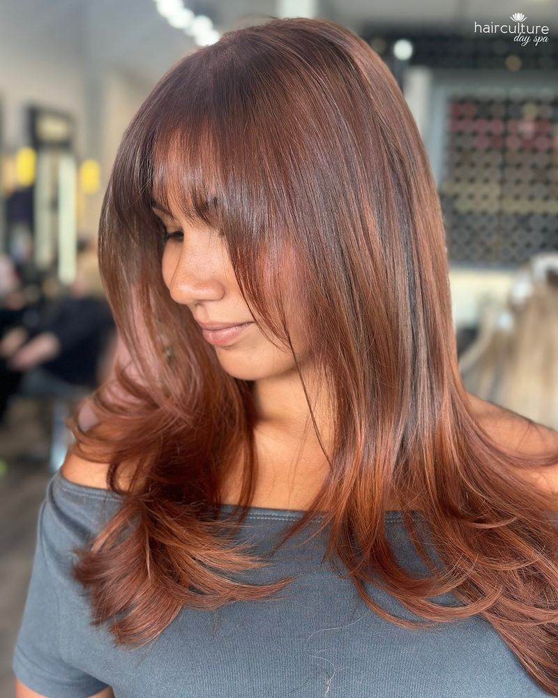 8. Layered Cinnamon Blowout with Soft Bangs