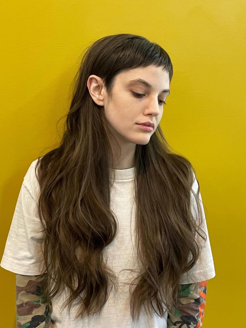 31. Long Brunette Waves with Micro Bangs