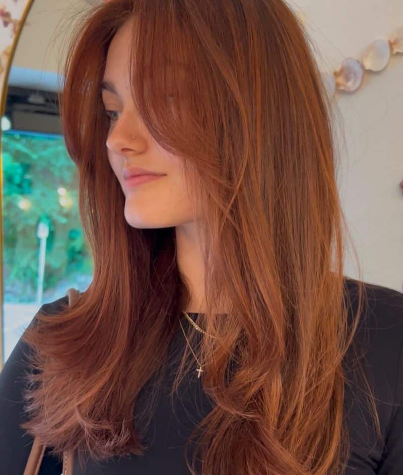 24. Long Copper Layers with Curtain Bangs