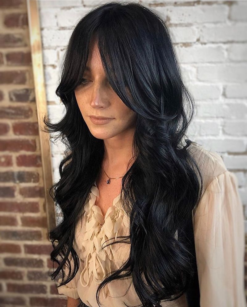 6. Long Layered Cut with Curtain Bangs