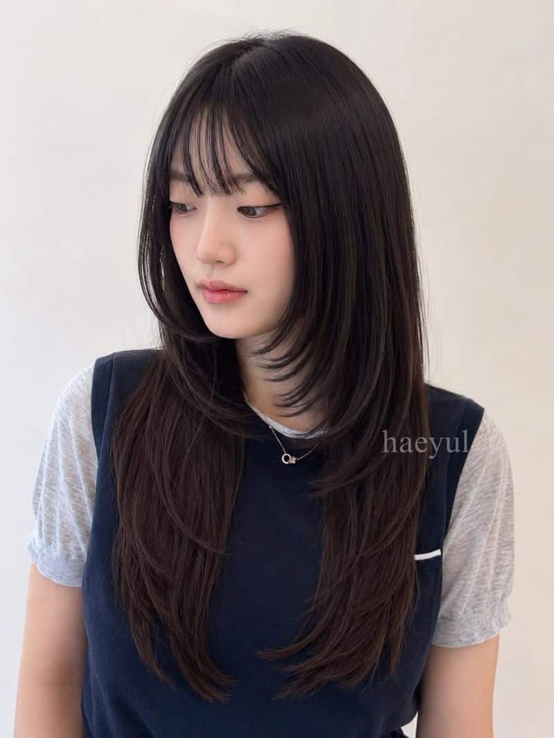 14. Long Layered Cut with See-Through Bangs