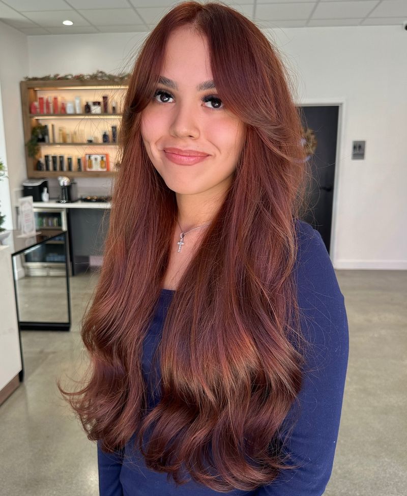 5. Long Layers with Curtained Bangs