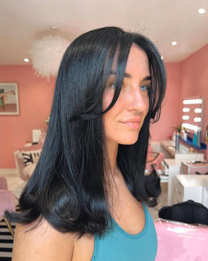18. Midnight Blue Blowout with Curtain Bangs