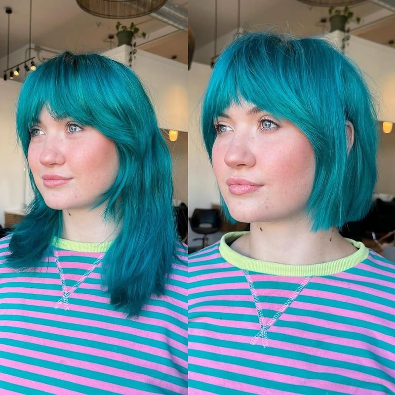 43. Neon Blue Shaggy Bob With Curtain Bangs