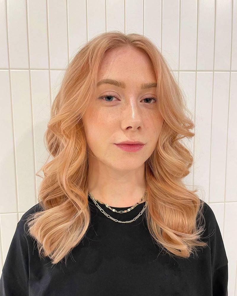 29. Peachy Curtain Bangs with Soft Waves