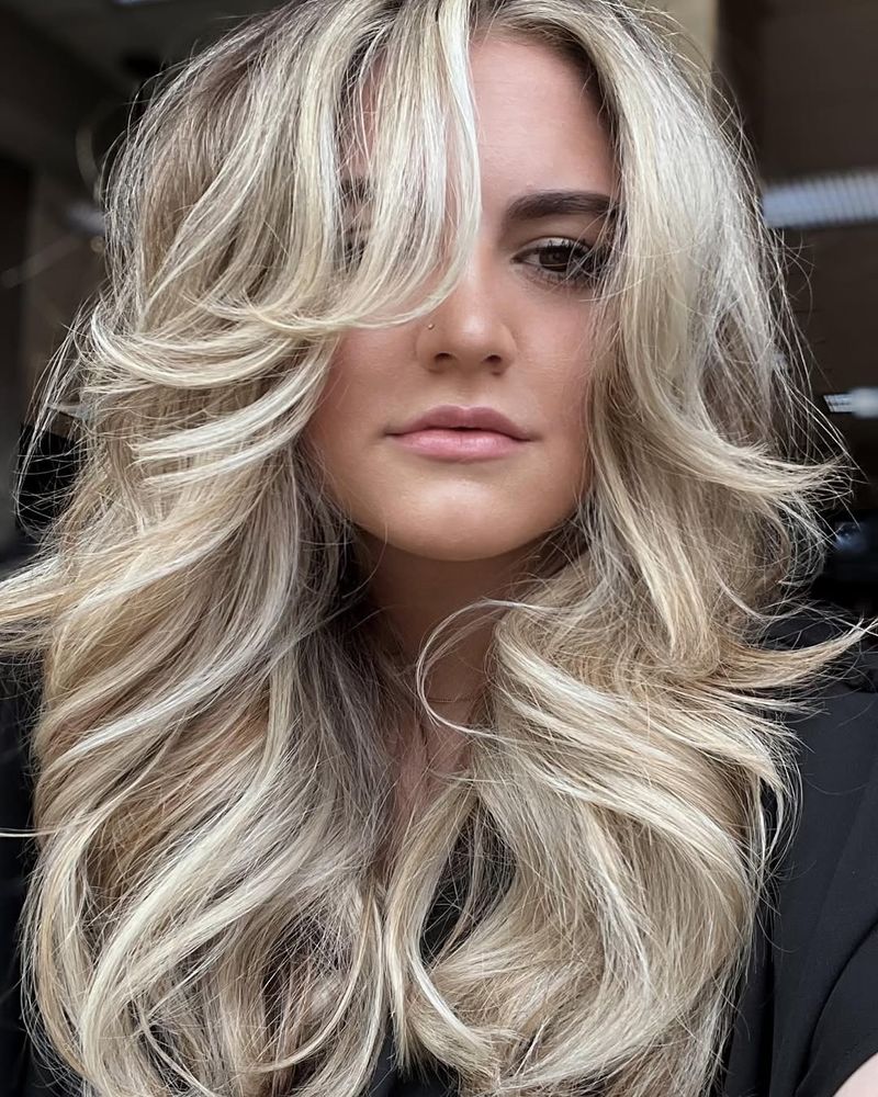 38. Platinum 70s Layers with Voluminous Curtain Bangs