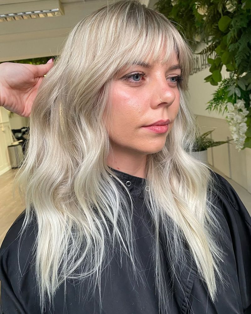 23. Platinum Ash Blonde Shag with Wispy Bangs
