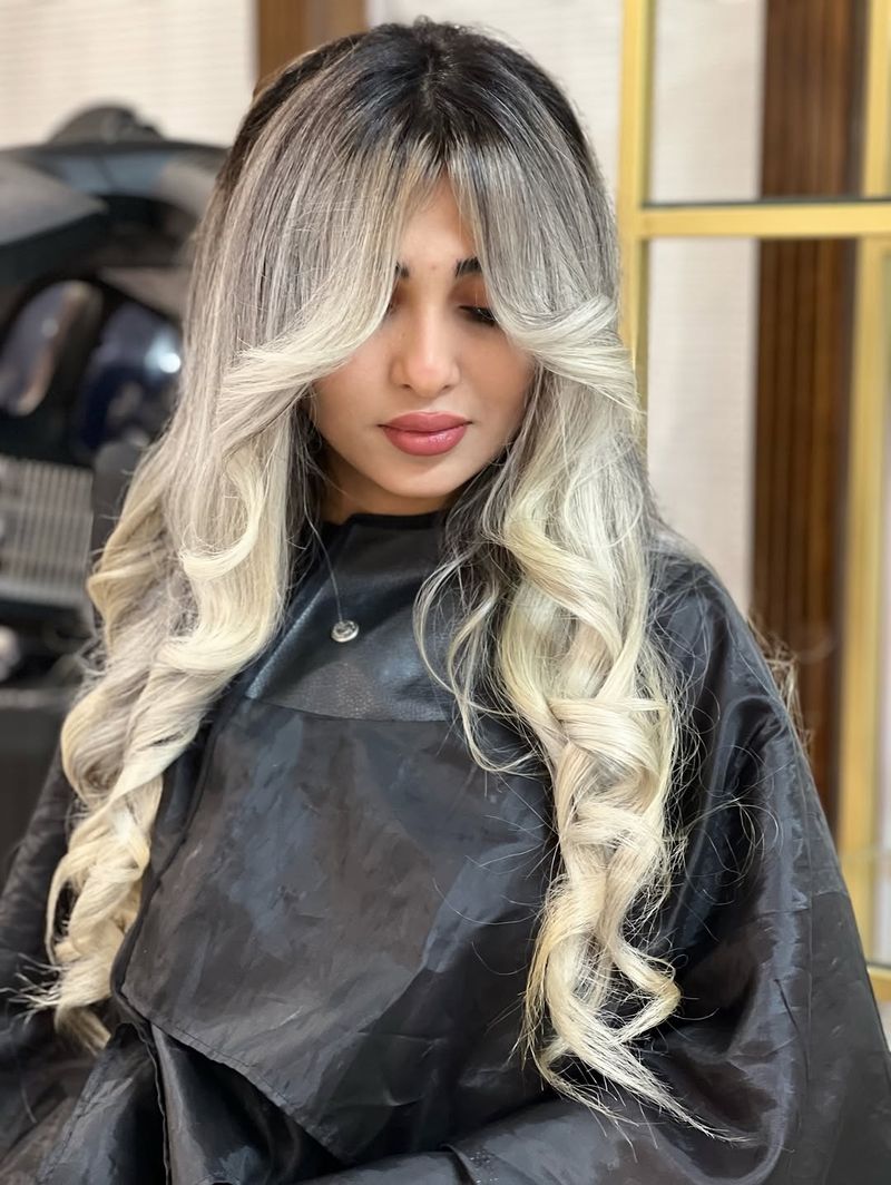 23. Platinum Blonde Curls with Smudged Roots