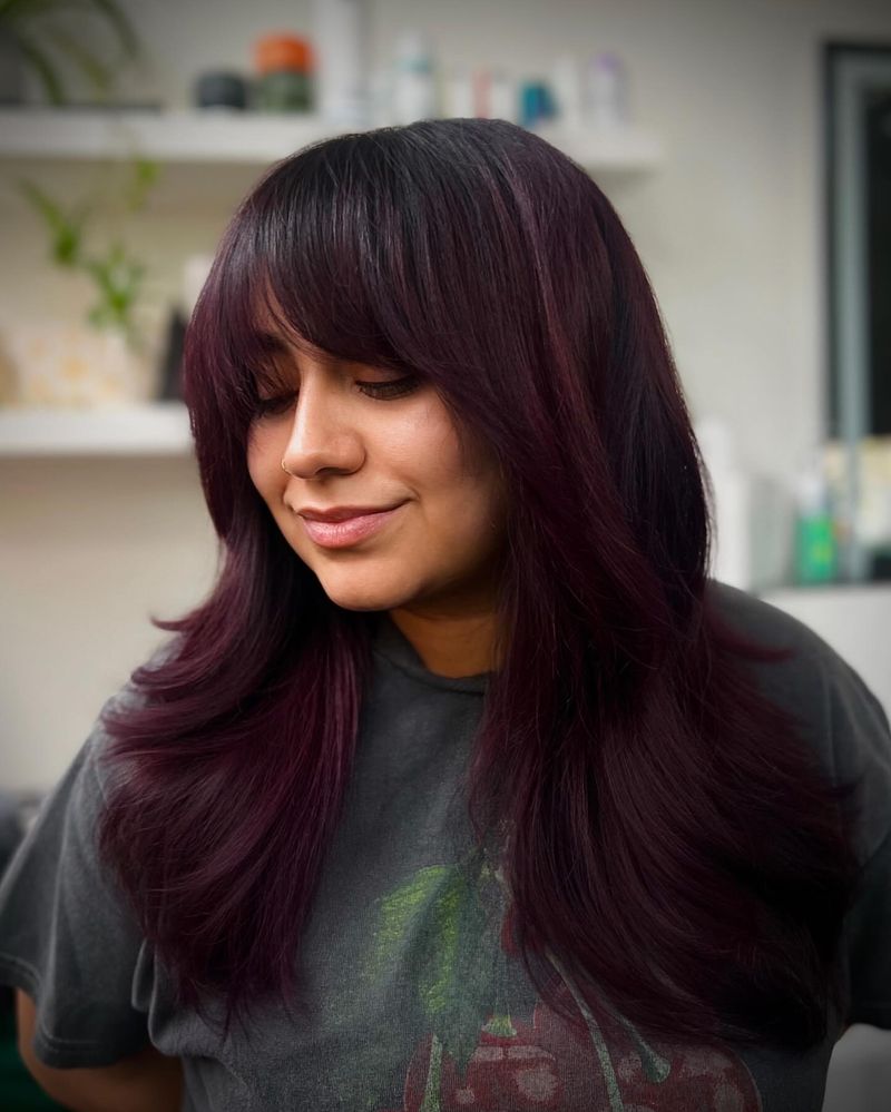 48. Plum-Toned Layers with Full Bangs