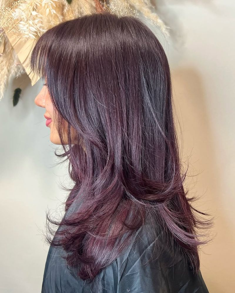 46. Plum-Toned Layers with Soft Bangs