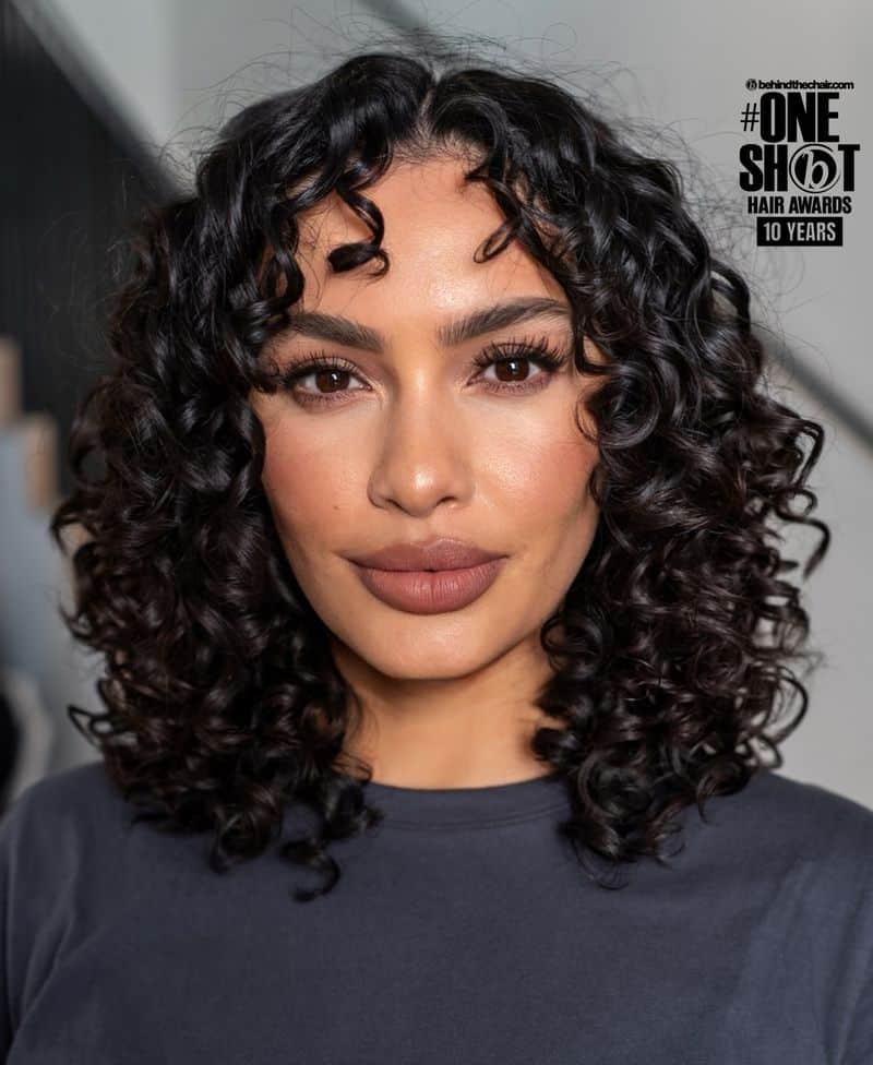12. Polished Spiral Curls with Soft Fringe
