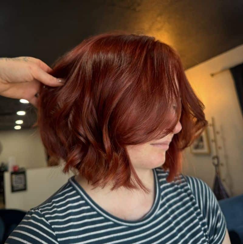 34. Rich Copper Wavy Bob with Curtain Bangs
