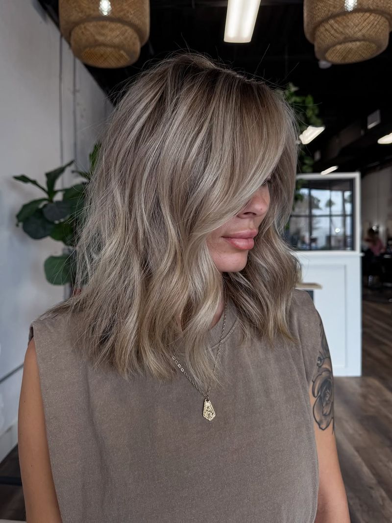 2. Root-Smudged Lob with Curtain Bangs
