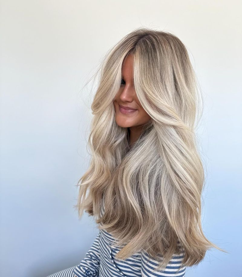 33. Root-Smudged Vanilla Blonde with Dramatic Curtain Bangs