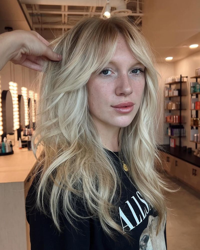 20. Sandy Blonde Shag with Long Curtain Bangs
