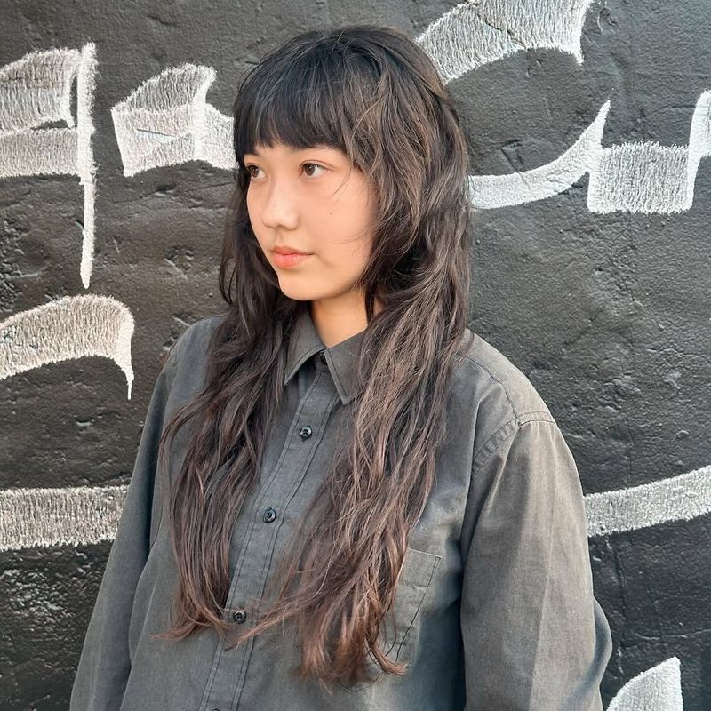 3. Shaggy Long Layers with Micro Bangs