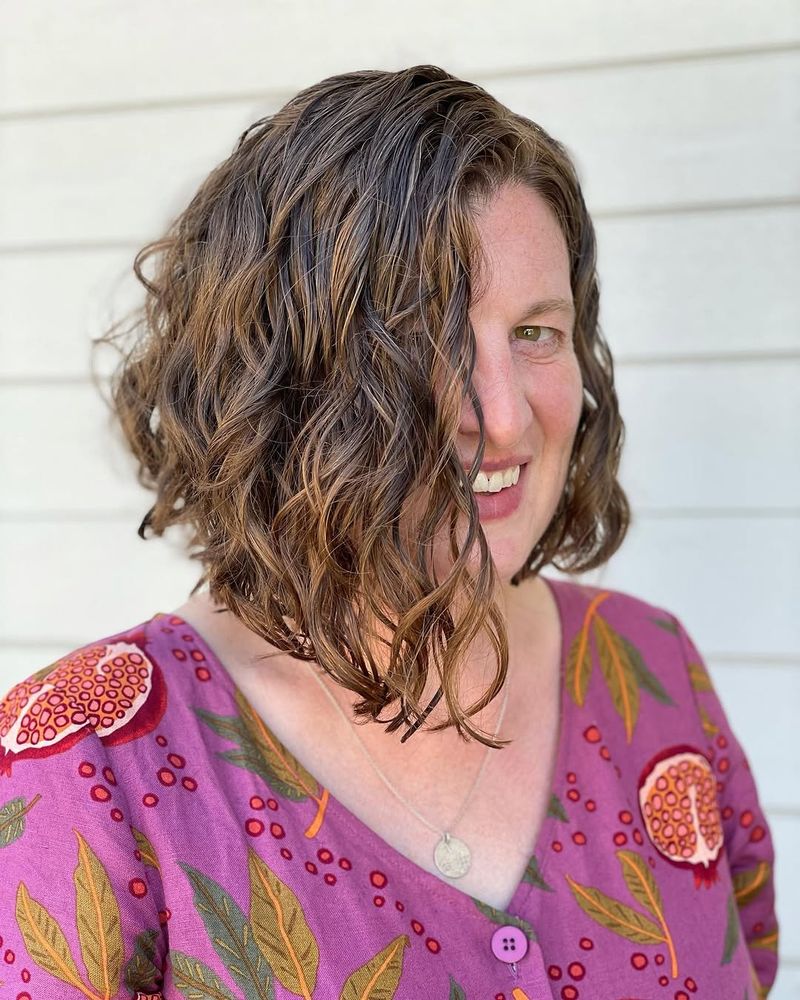 57. Side-Swept Caramel Wave Lob