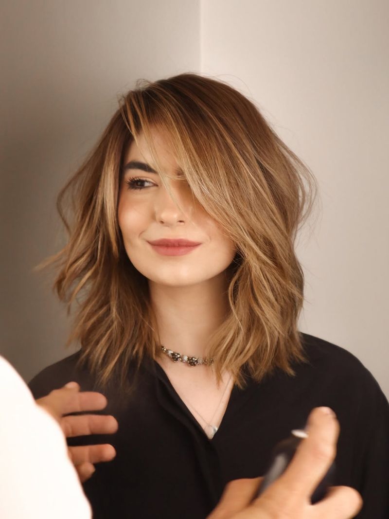 32. Side-Swept Honey Lob with Feathered Layers