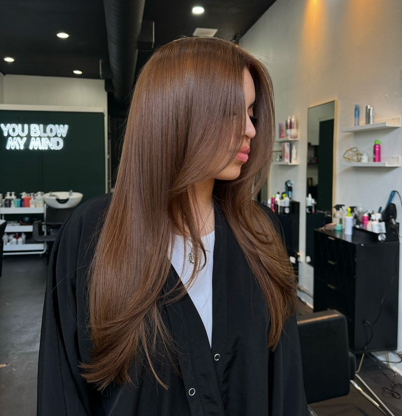 4. Silky Layers and Curtain Bangs