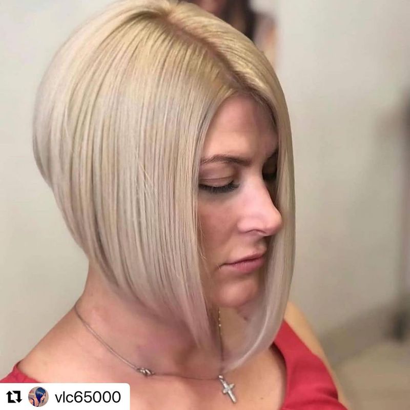 64. Sleek Angled Platinum Bob