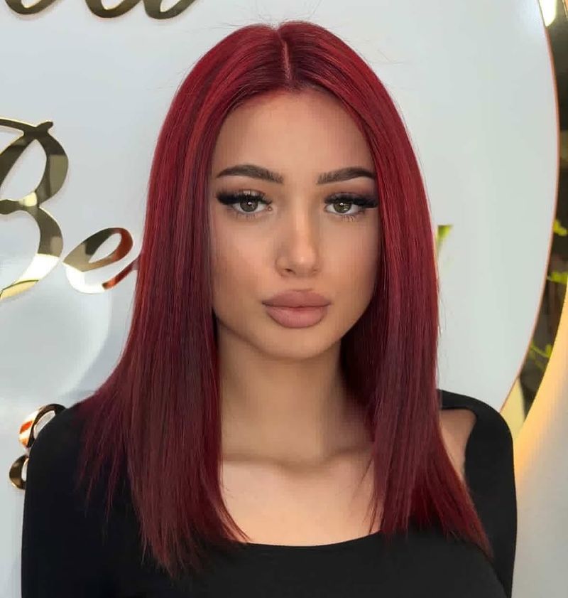 5. Sleek Crimson Mid-Length Cut