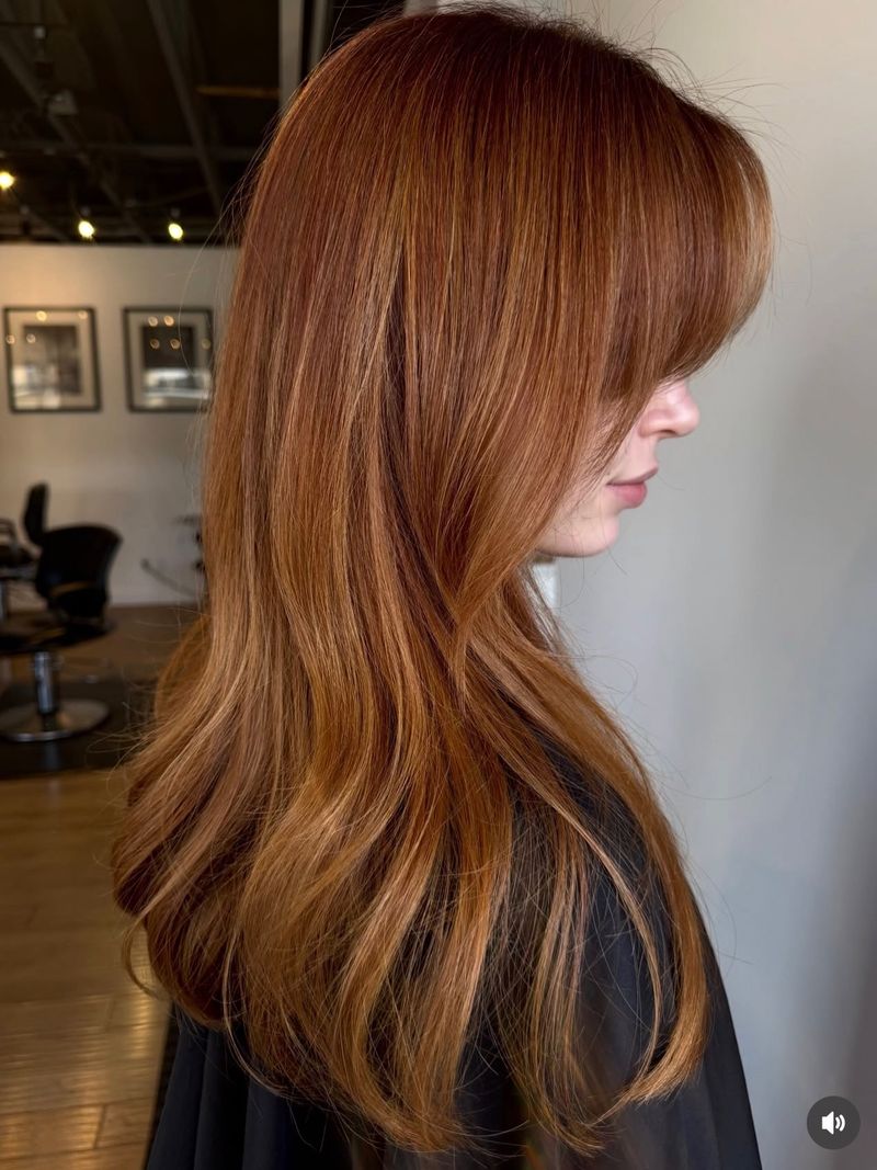 2. Sleek Layers with Full Bangs
