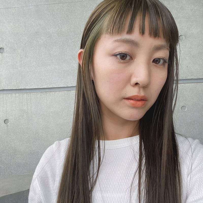 7. Sleek Lengths with Micro Bangs and Hidden Jade Highlights