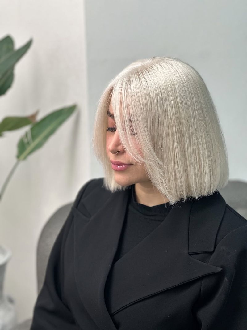 26. Sleek Platinum Lob with Face-Framing Fringe