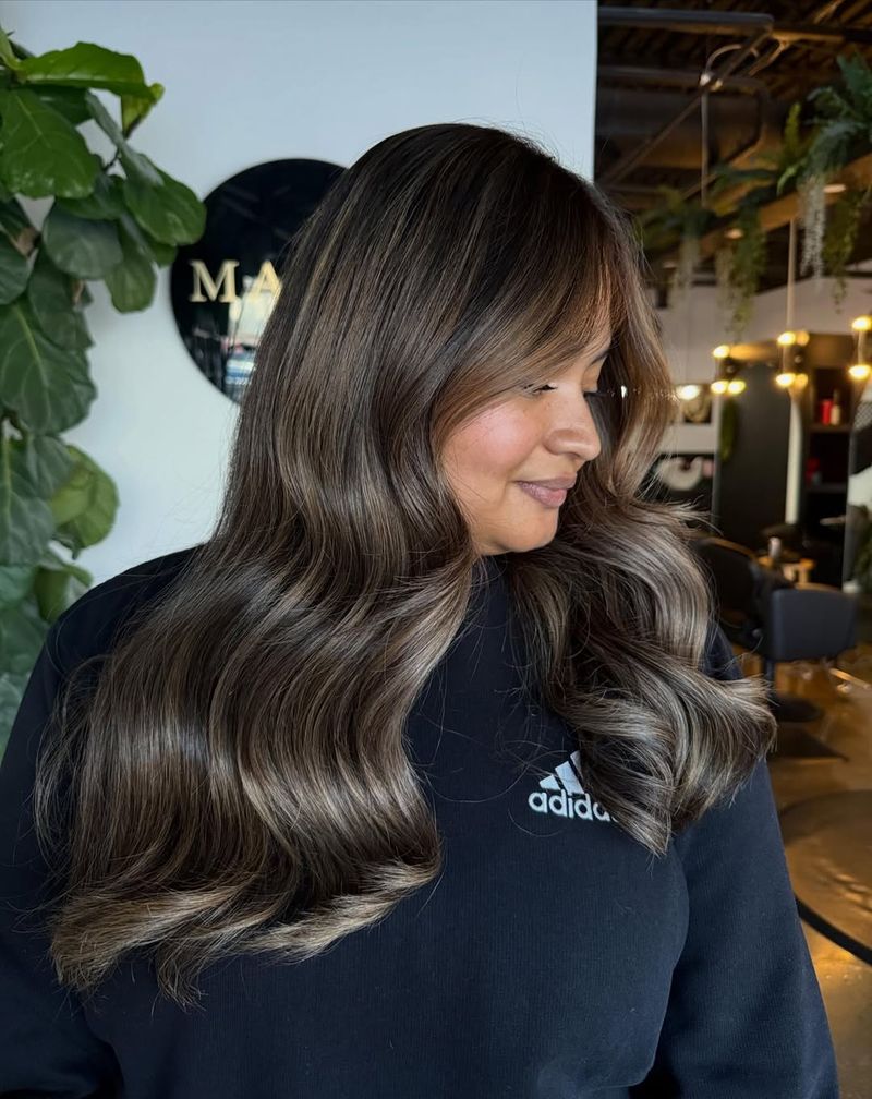 12. Smoky Brunette Waves with Soft Highlights