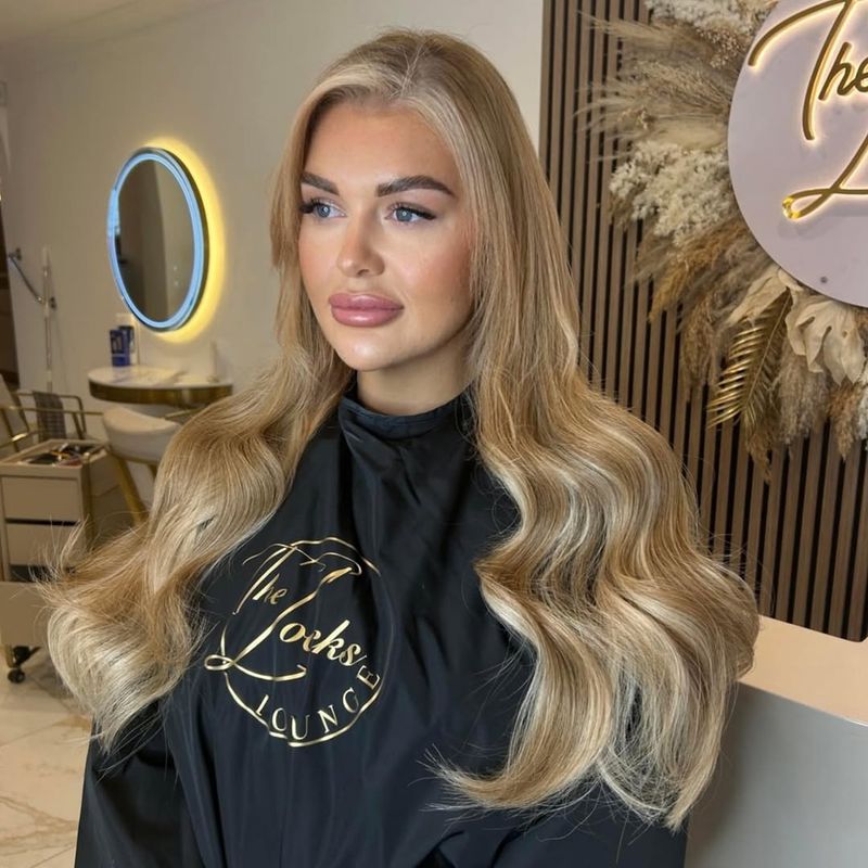27. Soft Apricot Waves with Bright Face-Framing Highlights